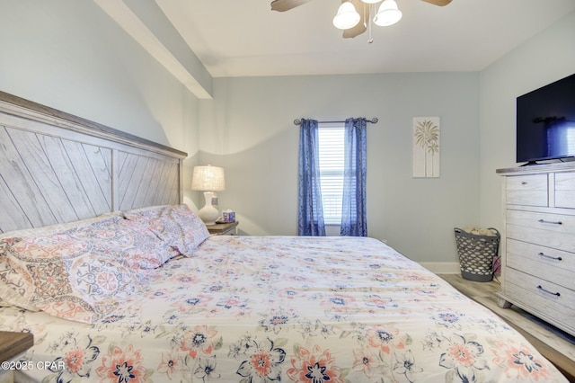 bedroom with baseboards, a ceiling fan, and wood finished floors