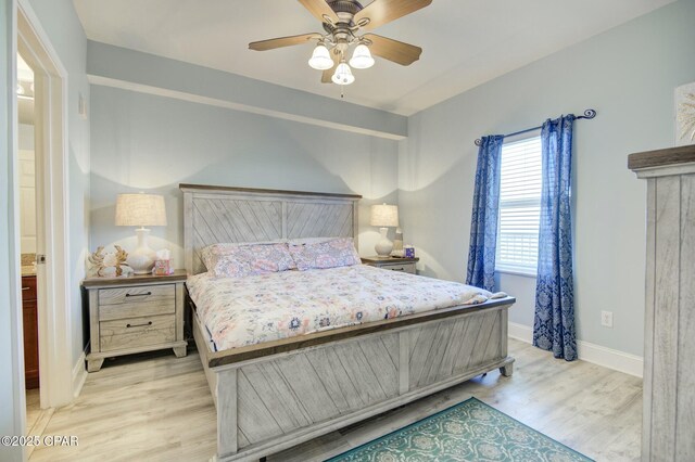 bedroom featuring light wood-type flooring, baseboards, and a ceiling fan