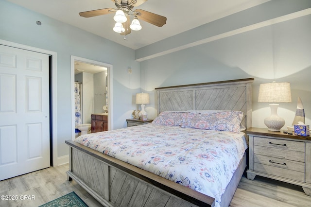 bedroom featuring ensuite bath and light wood-style floors