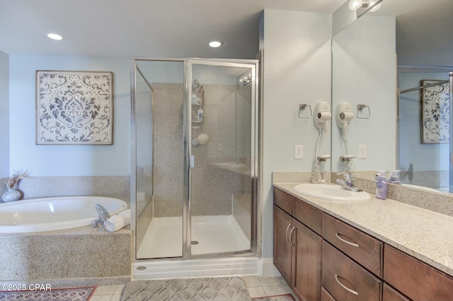 full bathroom with a stall shower, tile patterned floors, vanity, a bath, and recessed lighting