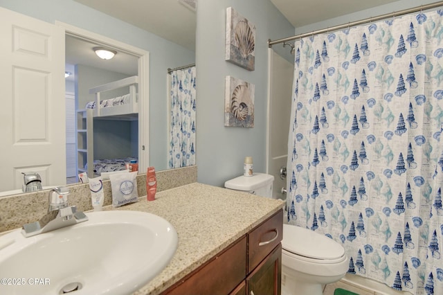 bathroom with toilet, a shower with shower curtain, and vanity