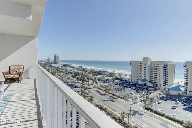 balcony featuring a water view and a city view