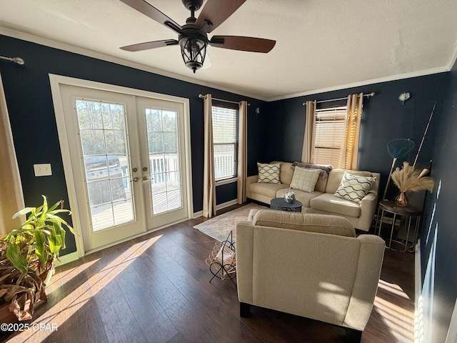 living room with a textured ceiling, a ceiling fan, ornamental molding, french doors, and dark wood finished floors