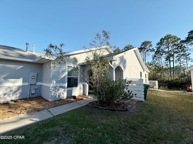 view of front of property with a front yard and stucco siding