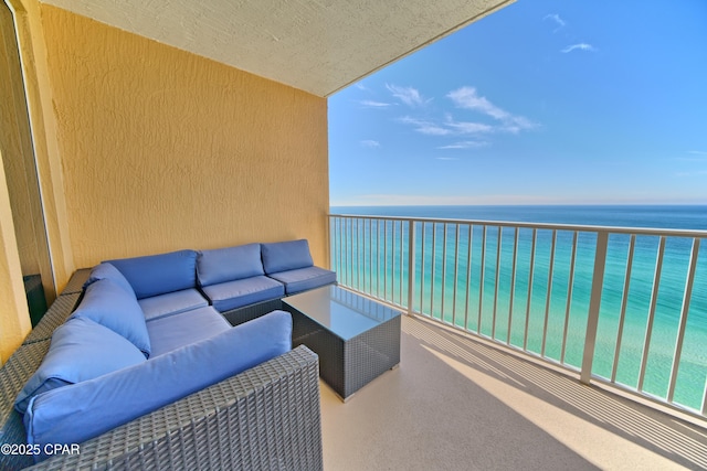 balcony with a water view and an outdoor hangout area