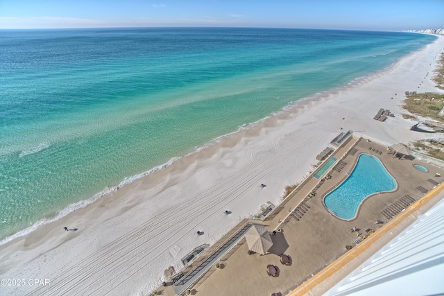 bird's eye view featuring a water view and a beach view