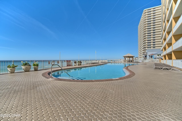 pool with a water view and a gazebo