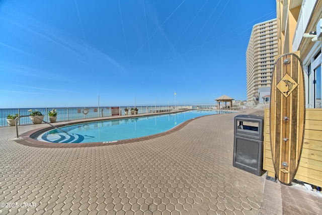 view of pool with a water view