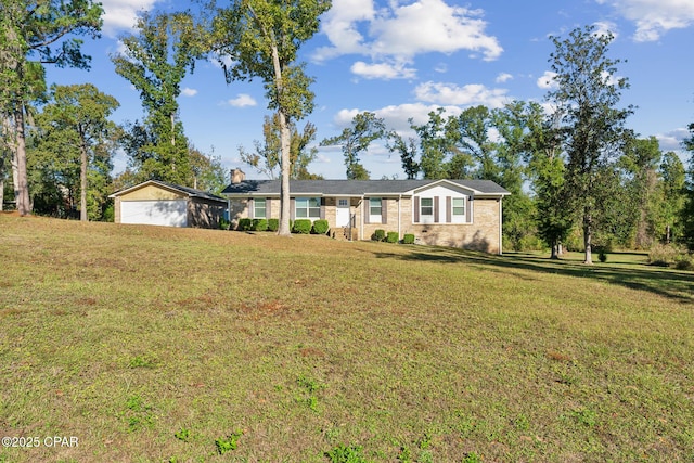 single story home with a front lawn and an outdoor structure