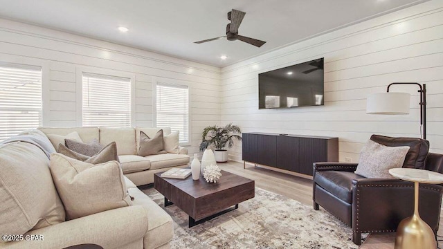 living room featuring recessed lighting, a ceiling fan, and light wood-style floors