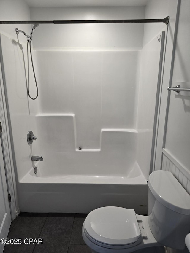 bathroom with shower / bathtub combination, toilet, and tile patterned floors