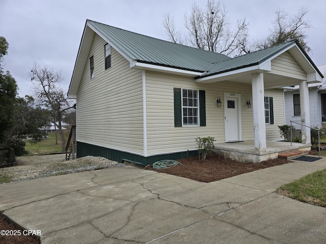 view of front of home with covered porch and metal roof