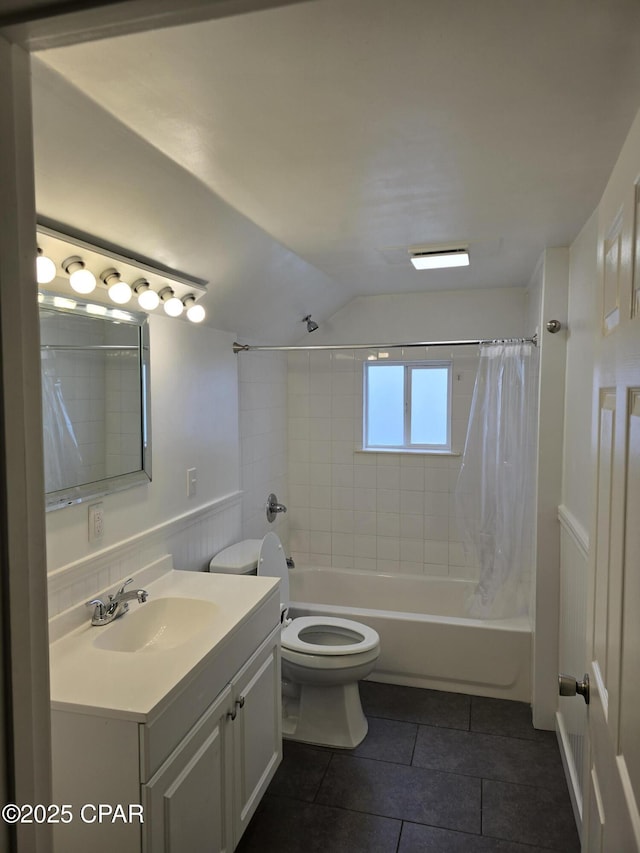 full bath with toilet, a wainscoted wall, shower / tub combo with curtain, tile patterned floors, and vanity