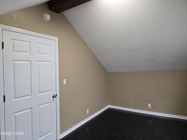 additional living space with lofted ceiling and baseboards