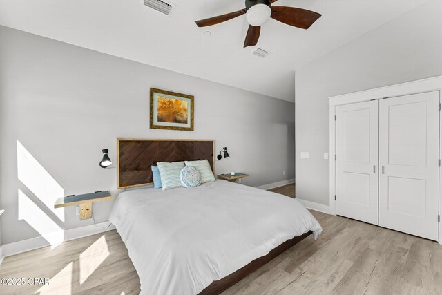 bedroom featuring visible vents, a ceiling fan, baseboards, and wood finished floors