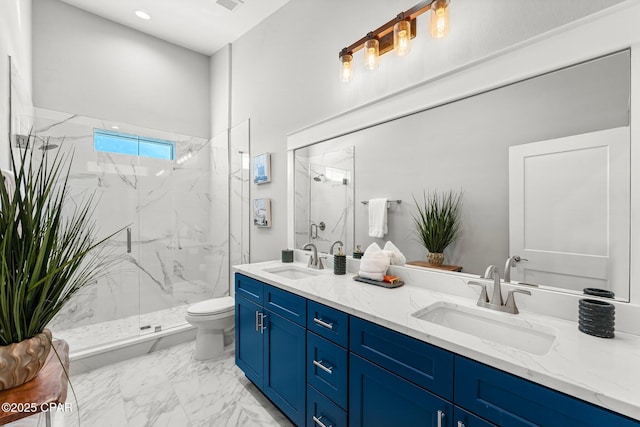 bathroom featuring a marble finish shower, marble finish floor, and a sink