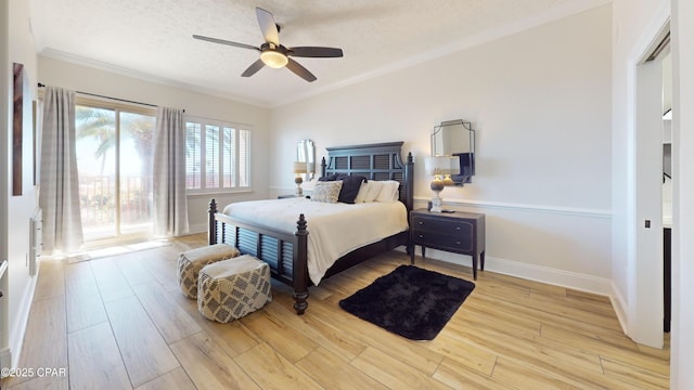 bedroom with light wood-style floors, baseboards, ornamental molding, and a textured ceiling