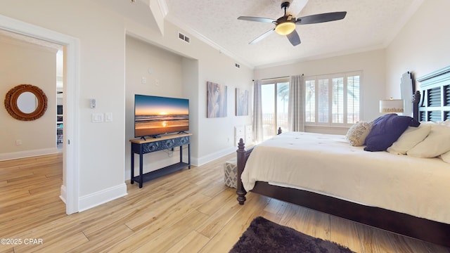 bedroom with a textured ceiling, light wood-style flooring, visible vents, and crown molding