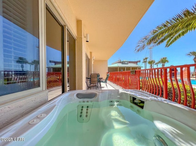 view of pool with a hot tub