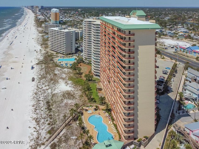 bird's eye view featuring a water view, a view of the beach, and a city view