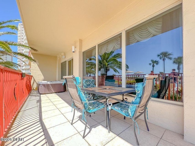 view of patio / terrace featuring outdoor dining space and a hot tub