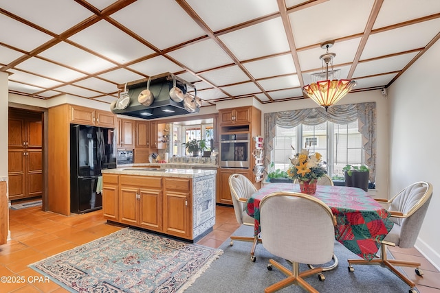 kitchen with freestanding refrigerator, light countertops, a wealth of natural light, and oven