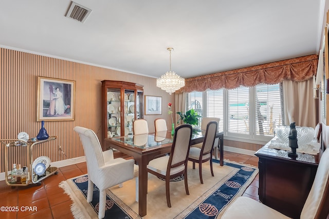 dining space with baseboards, visible vents, an inviting chandelier, and light tile patterned floors