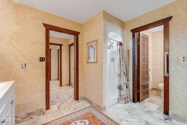 corridor with marble finish floor and wallpapered walls