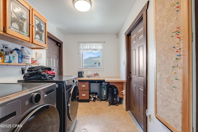 laundry area featuring cabinet space, light tile patterned floors, and washer and dryer