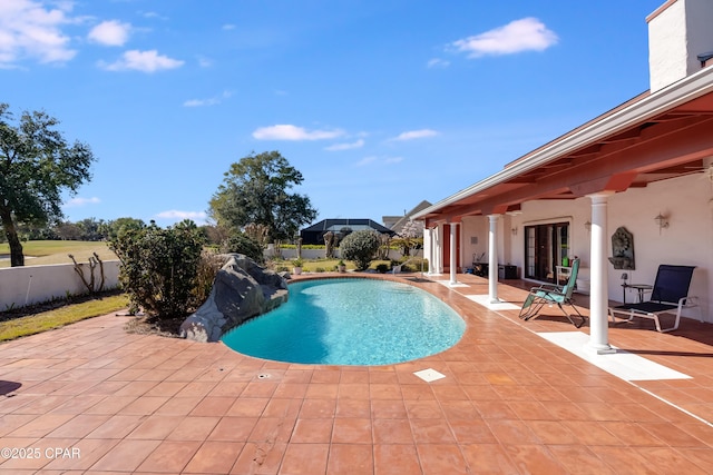 view of swimming pool featuring a patio, french doors, fence, and a fenced in pool