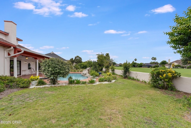 view of yard featuring a patio, fence, a fenced in pool, and a ceiling fan