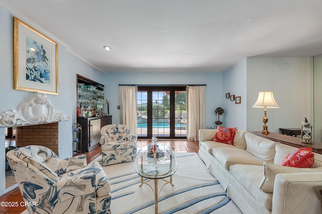 living room with a bar, crown molding, and french doors