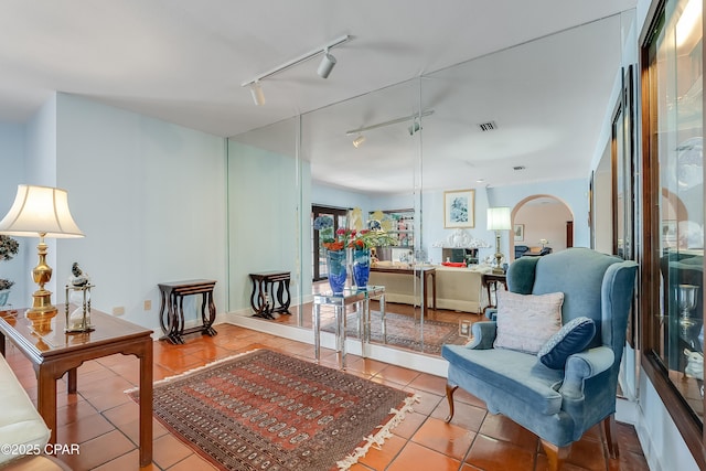 living area with visible vents and tile patterned floors