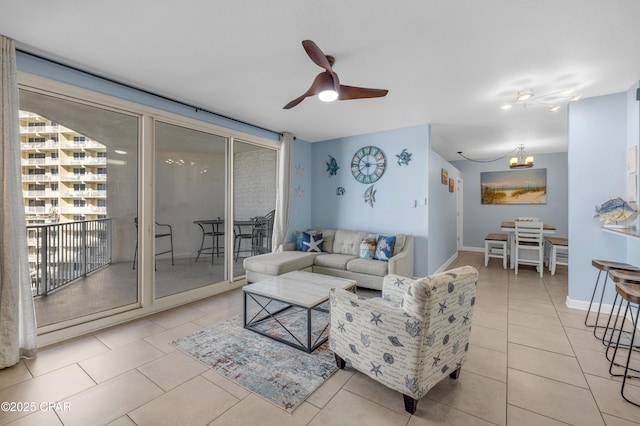 tiled living room with ceiling fan and baseboards