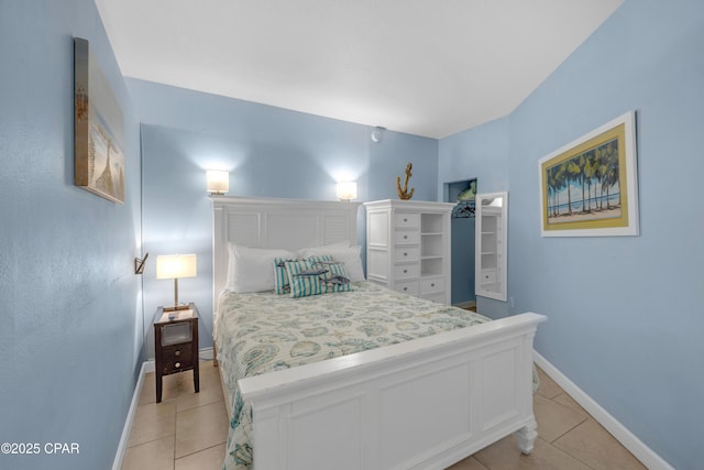 bedroom with light tile patterned flooring and baseboards