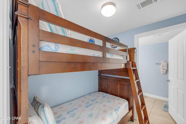 bedroom with visible vents, baseboards, and light tile patterned floors