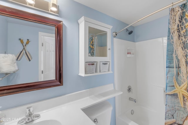 bathroom featuring shower / bath combo with shower curtain and vanity