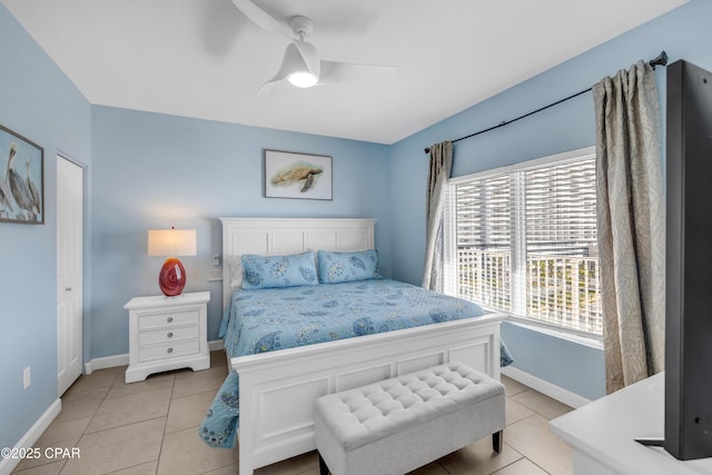 bedroom with baseboards, a ceiling fan, and light tile patterned flooring