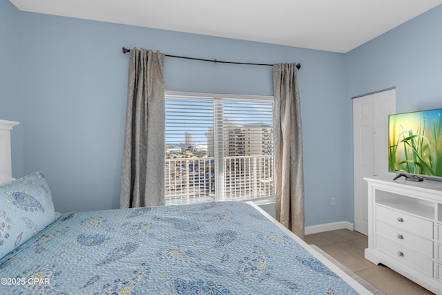 bedroom with light tile patterned flooring and baseboards