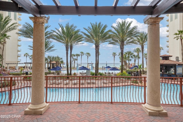 community pool featuring a patio area and fence