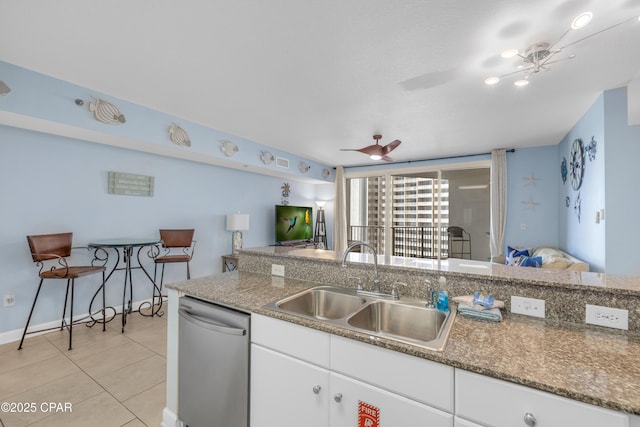 kitchen featuring dishwasher, ceiling fan, white cabinetry, a sink, and light tile patterned flooring