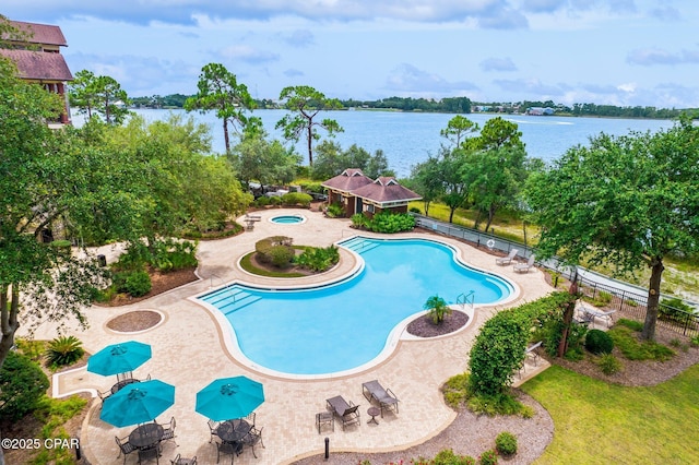 pool with fence and a water view