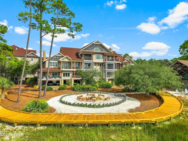 view of property's community featuring an outdoor fire pit