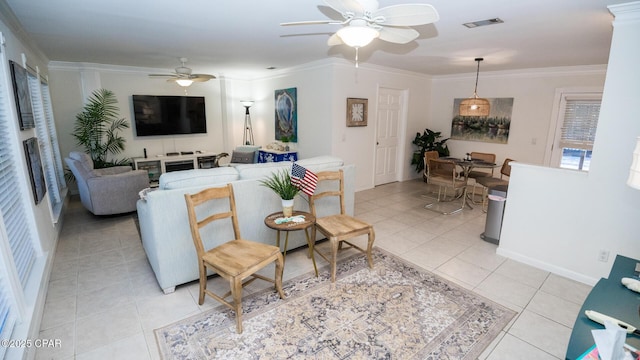 living room featuring light tile patterned floors, a ceiling fan, visible vents, and crown molding