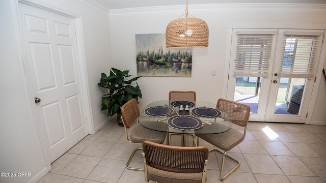 dining room featuring light tile patterned floors, baseboards, ornamental molding, and french doors