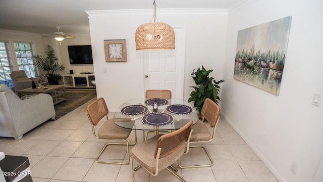 dining area featuring light tile patterned floors, baseboards, ornamental molding, and ceiling fan