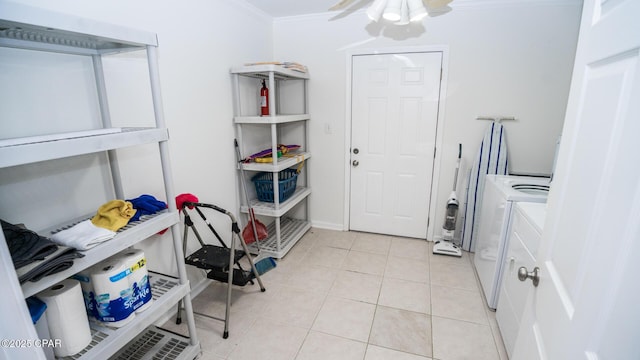 clothes washing area featuring ceiling fan, light tile patterned flooring, laundry area, washer and dryer, and ornamental molding