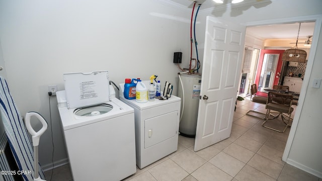 laundry room with washing machine and clothes dryer, light tile patterned floors, water heater, ornamental molding, and laundry area