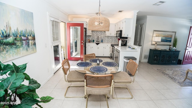 dining room featuring light tile patterned floors, ornamental molding, decorative columns, and visible vents