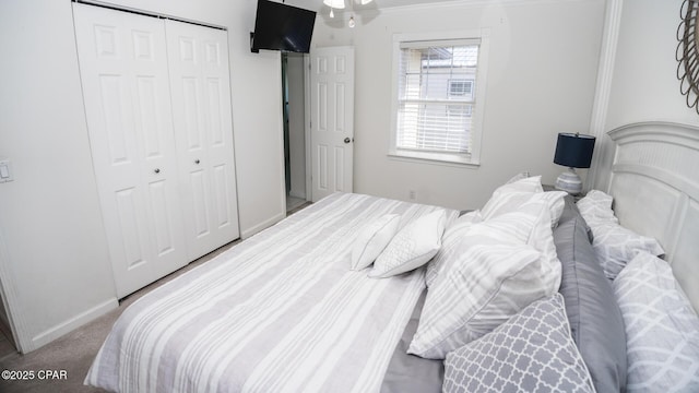 carpeted bedroom featuring a closet and baseboards